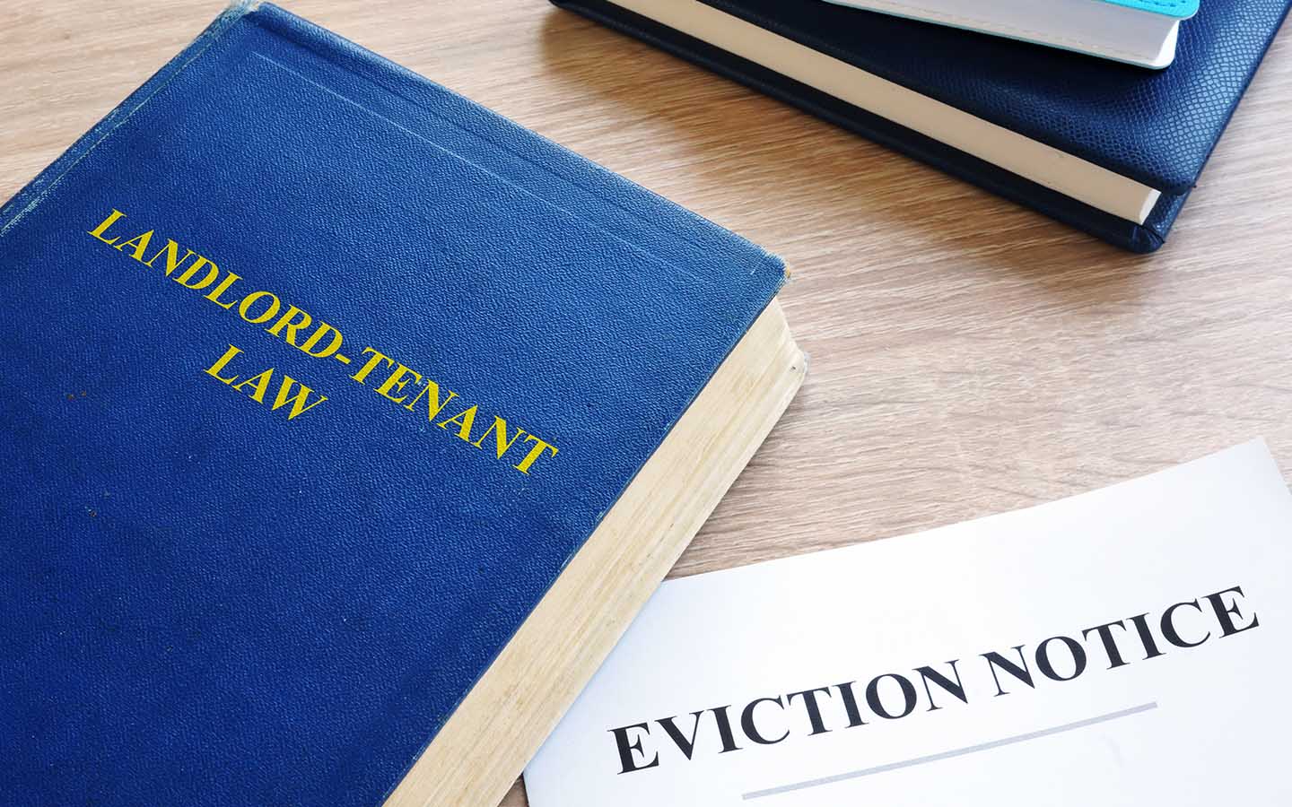 Book titled Landlord-Tenant Law lying beside a printed eviction notice